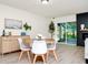 Bright dining area with modern furniture, stylish decor, and a view of the fireplace and outdoor area at 10118 Allenby Ct, Orlando, FL 32821