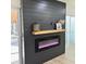 Modern electric fireplace with a dark wood mantel and shiplap surround at 10118 Allenby Ct, Orlando, FL 32821