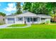 Charming single-story home with a well-manicured lawn, cozy front porch, and attached garage at 10118 Allenby Ct, Orlando, FL 32821