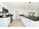 Elegant kitchen with granite countertops, stainless steel appliances, white cabinets, and a modern faucet at 10118 Allenby Ct, Orlando, FL 32821