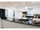 Modern kitchen with white cabinets, granite countertops, and a large island at 10118 Allenby Ct, Orlando, FL 32821