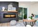 Contemporary living room with a sleek electric fireplace, stylish decor, and a sliding glass door at 10118 Allenby Ct, Orlando, FL 32821