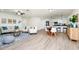 Bright and airy living room featuring hardwood floors, modern furniture, and an open floor plan to the kitchen at 10118 Allenby Ct, Orlando, FL 32821
