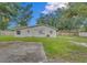 Large backyard with grassy area and a paved parking space at 1142 Grayson Dr, Orlando, FL 32825