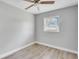 Simple bedroom with grey walls, hardwood floor and a window at 1142 Grayson Dr, Orlando, FL 32825