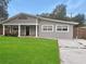 Newly painted house with a well-maintained lawn and driveway at 1142 Grayson Dr, Orlando, FL 32825