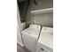 Bright laundry room with washer, dryer, and shelving at 1142 Grayson Dr, Orlando, FL 32825