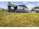 Large backyard offering a grassy area and a view of the surrounding neighborhood at 12331 Warren Rd, Clermont, FL 34711