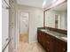 Elegant bathroom with double vanity, granite countertops, and a large mirror at 12331 Warren Rd, Clermont, FL 34711