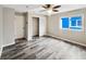 Spacious bedroom with wood-look floors and ceiling fan at 12331 Warren Rd, Clermont, FL 34711