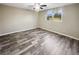 Well-lit bedroom featuring grey wood-look flooring and neutral wall tones at 12331 Warren Rd, Clermont, FL 34711