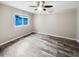 Bright bedroom with wood-look floors and ceiling fan at 12331 Warren Rd, Clermont, FL 34711