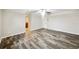 Spacious bedroom with wood-look floors and access to bathroom at 12331 Warren Rd, Clermont, FL 34711