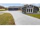 Updated home with stone exterior and large driveway at 12331 Warren Rd, Clermont, FL 34711