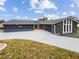 Updated home exterior, showcasing a new paint job and landscaping at 12331 Warren Rd, Clermont, FL 34711