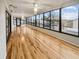 Bright sunroom featuring hardwood floors and large windows at 12331 Warren Rd, Clermont, FL 34711