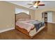 Main bedroom with large bed, ceiling fan and hardwood floors at 126 Se 41St Ave, Ocala, FL 34471