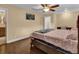 Bedroom with large bed, ceiling fan, and hardwood floors at 126 Se 41St Ave, Ocala, FL 34471