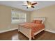 Bright bedroom with wood floors, ceiling fan, and a double bed at 126 Se 41St Ave, Ocala, FL 34471