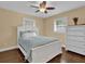 Bedroom with white wooden bed frame, ceiling fan, and hardwood floors at 126 Se 41St Ave, Ocala, FL 34471