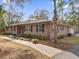 Tan house with stone accents, landscaping, and a spacious lawn at 126 Se 41St Ave, Ocala, FL 34471