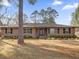 Tan house with stone accents, landscaping, and a spacious lawn at 126 Se 41St Ave, Ocala, FL 34471