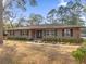 Tan house with stone accents, landscaping, and a spacious lawn at 126 Se 41St Ave, Ocala, FL 34471