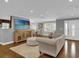 Spacious living room with hardwood floors, comfortable seating, and large TV at 126 Se 41St Ave, Ocala, FL 34471