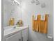Bright bathroom featuring a vanity with a white countertop, decorative mirror and stylish 'P' monogrammed towels at 127 Westmoreland Cir, Kissimmee, FL 34744