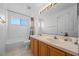 Bright bathroom featuring double vanity sinks, a tub and natural light at 127 Westmoreland Cir, Kissimmee, FL 34744