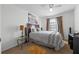 Comfortable bedroom featuring a large window, carpet, and decorative accents at 127 Westmoreland Cir, Kissimmee, FL 34744