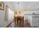 Dining area features natural light from a large window and open access to the kitchen at 127 Westmoreland Cir, Kissimmee, FL 34744