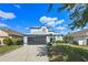 Inviting two-story home featuring a well-kept lawn and a convenient two-car garage at 127 Westmoreland Cir, Kissimmee, FL 34744