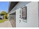 Close up showing address numbers on wall with an updated modern outdoor light fixture at 127 Westmoreland Cir, Kissimmee, FL 34744