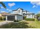 Inviting two-story home featuring a well-kept lawn and a convenient two-car garage at 127 Westmoreland Cir, Kissimmee, FL 34744