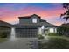 Charming two-story home with a well-manicured lawn, beautiful windows, and a spacious two-car garage at 127 Westmoreland Cir, Kissimmee, FL 34744
