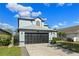 Charming two-story home with a well-manicured lawn, beautiful windows, and a spacious two-car garage at 127 Westmoreland Cir, Kissimmee, FL 34744