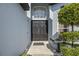 Welcoming front entrance with a black double door and manicured landscaping at 127 Westmoreland Cir, Kissimmee, FL 34744