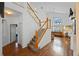 Hallway featuring a staircase with wood and white railings and hardwood floors at 127 Westmoreland Cir, Kissimmee, FL 34744
