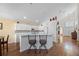 Bright eat-in kitchen with white cabinetry, island with seating, and stainless steel appliances at 127 Westmoreland Cir, Kissimmee, FL 34744