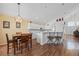 Bright open floor plan with kitchen and dining area, featuring white cabinets and stainless steel appliances at 127 Westmoreland Cir, Kissimmee, FL 34744