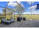 Outdoor living with lounge seating, overlooking golf course and blue skies at 127 Westmoreland Cir, Kissimmee, FL 34744