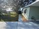 Side view of a light green house with walkway at 1311 E Schwartz E Blvd, Lady Lake, FL 32159