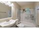 Bathroom with marble style tiled shower and walls plus a white vanity and matching toilet at 1335 Lescot Ln, Orlando, FL 32811