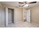 Spacious bedroom with closet, ceiling fan, tile floor and open door to hallway at 1335 Lescot Ln, Orlando, FL 32811