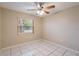 Cozy bedroom featuring a ceiling fan, and natural light through a large window at 1335 Lescot Ln, Orlando, FL 32811
