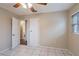 This bedroom features tile flooring, a ceiling fan, and access to an ensuite bathroom at 1335 Lescot Ln, Orlando, FL 32811