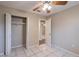 Bedroom with closet, ceiling fan, tile floor and open door to hallway at 1335 Lescot Ln, Orlando, FL 32811