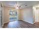 Bright dining area with hardwood floors, ceiling fan, and sliding glass doors leading to a screened-in porch at 1335 Lescot Ln, Orlando, FL 32811