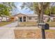 Charming single-story home featuring a covered parking area and a well-maintained front yard at 1335 Lescot Ln, Orlando, FL 32811